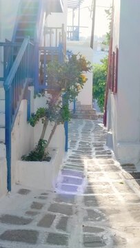 Walking with steadycam steadicam in picturesque scenic narrow streets with traditional whitewashed houses with blue doors windows of Mykonos town in famous tourist attraction Mykonos island, Greece