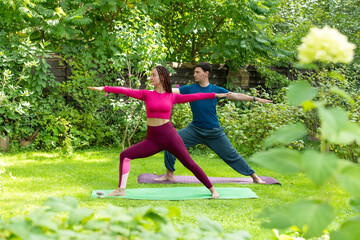 couple doing yoga in nature - 780968189