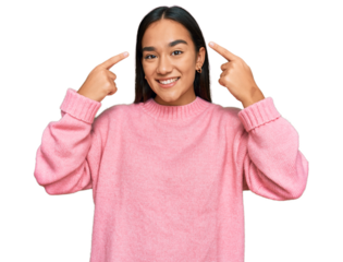 Young asian woman wearing casual winter sweater smiling pointing to head with both hands finger, great idea or thought, good memory