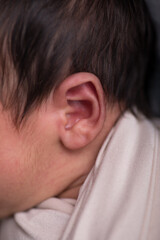 Fototapeta premium Close up macro photography of a newborn baby ear person attention listen