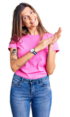 Beautiful caucasian woman wearing casual clothes clapping and applauding happy and joyful, smiling proud hands together