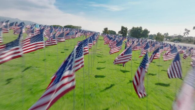A rapid aerial sweep captures the poignant display of 3000 American flags in honor of the 9.11 terror attack victims. Footage 4K. 