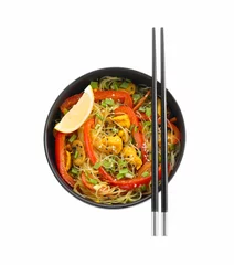  Stir-fry. Delicious cooked noodles with chicken and vegetables in bowl isolated on white, top view © New Africa
