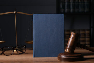 Law. Book, gavel, scales and glasses on wooden table