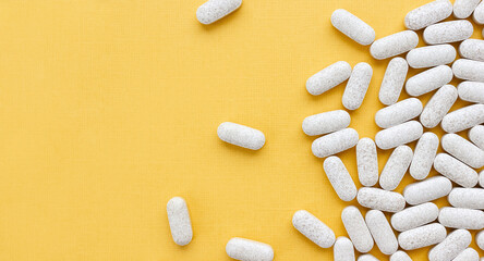 Dietary supplement with vitamin C and citrus bioflavonoid on yellow background. Medical banner....
