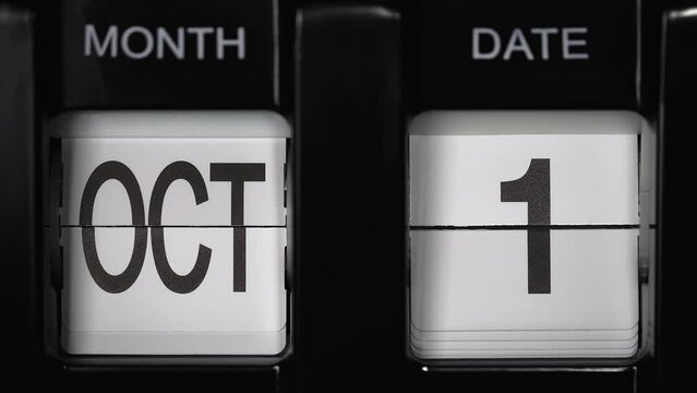 retro flip calendar with a date change from the thirty-first of October to the first of November. daily calendar with a change of days of the month. close up.