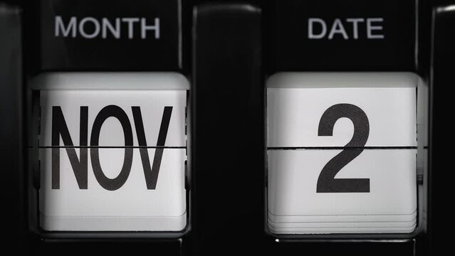 retro flip calendar with a date change from the first of November to the second of November. daily calendar with a change of days of the month. close up.