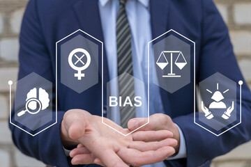Man using virtual screen sees word: BIAS. Bias model or implicit bias drives our explicit behavior,...