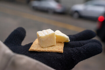 A hand holds a cheese cube at Seattle's Public Market. The homemade cheese is delicious and fresh....