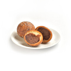 Redbean doughnut or bun in Japanese style. It is filled with red bean paste. It combines anpan or sweet red bean bun, jam pan, creamy pan, curry bread. Powdered or sifted sugar is applied to the bun