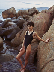 Sun-Kissed Seductress: A Stunning Brunette in Sexy Swimwear Poses on a Tropical Beach, Radiating Beauty and Confidence under the Clear Blue Sky