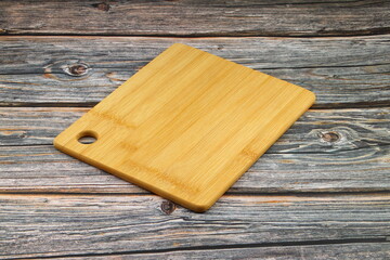 Wood cutting board for homemade bread cooking isolated on rusty background. Empty wooden tray at rusty