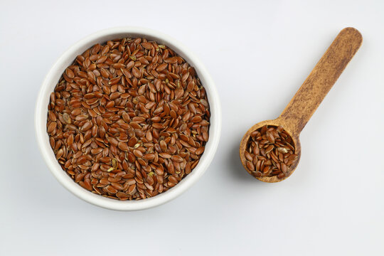 Pile of flax seeds isolated on white background