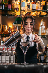 Female bartender preparing a cocktail in a traditional cocktail bar