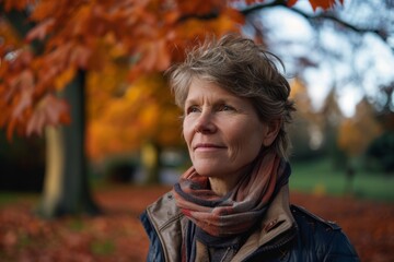 Portrait of a senior woman in the autumn park. Selective focus.