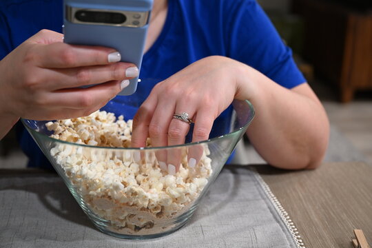 mindless snacking while surfing the internet on phone