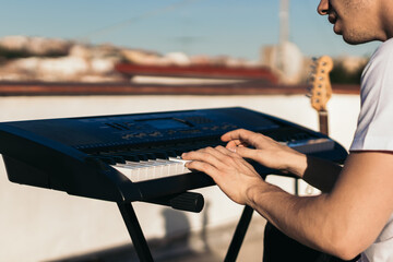 man playing piano on an urban rooftop