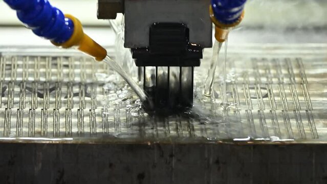 The graphite electrode working on EDM machine with liquid coolant method.