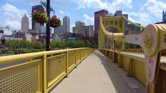 Walking over a bridge towards downtown Pittsburgh.