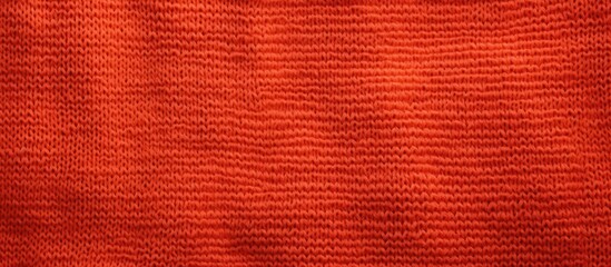Close-up view of a vibrant red sweater against a sleek black background - Powered by Adobe