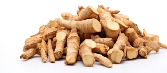 Fototapeta premium Pile of freshly cut ginger pieces arranged on a clean white background