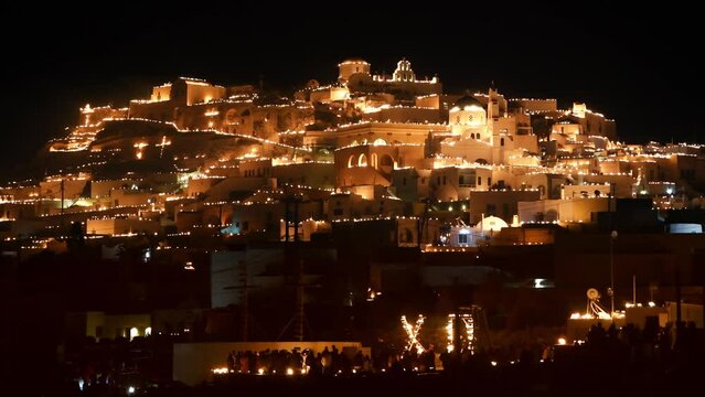 Santorini island, Greece. Easter Good Friday celebrations in Pyrgos village, Santorini, Greece. Candles with fire on the rooftops of the houses. Traditional orthodox easter in Greece - Powered by Adobe