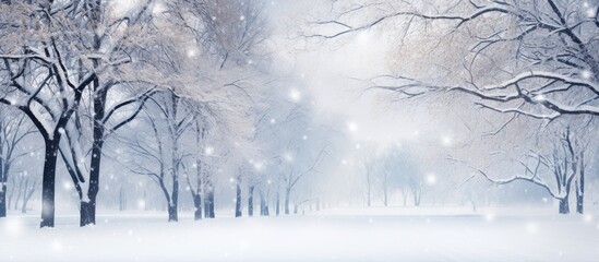 Snow gently falling on the snow-covered trees in a tranquil park setting, creating a peaceful winter scene