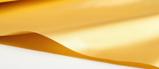 A detailed close-up of a vibrant yellow satin fabric texture, showcasing its smooth surface and rich color