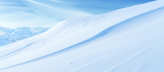 Fototapeta na wymiar Skiers gracefully ski down a snow-covered mountain under the clear blue sky, enjoying the winter scenery.