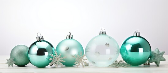 Green and silver Christmas decorations placed on a clean white table, creating a festive holiday ambiance