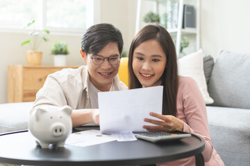 Happy asian young couple love, wife, husband calculate income and planning, saving money to buy...