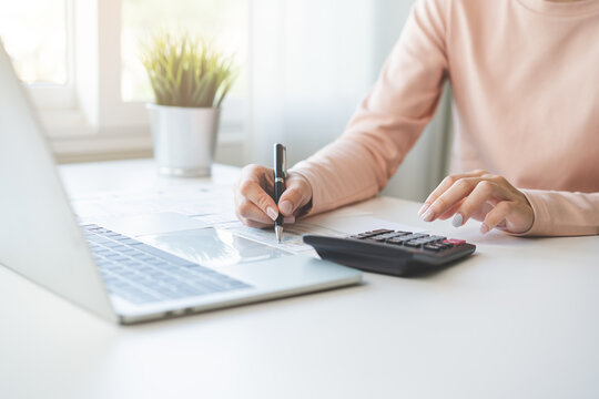 Deduction Planning, Debt Asian Young Woman  Hand Using Laptop Computer, Calculator Calculating Money Balance From Bill And Income, Cost Budget Expenses For Pay Money Form Personal Individual On Table.