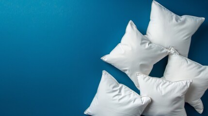 Three white pillows on a blue background