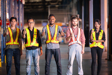 Portrait of group employees in the warehouse with thumb up