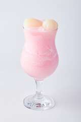Lychee Smoothie topped with fresh lychee isolated on white background.