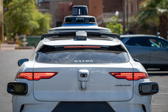 Phoenix, Arizona, USA - 3.23.2024: Behind a Waymo self-driving car stopped at an intersection.
