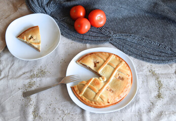 Freshly baked round tuna pie on beige background