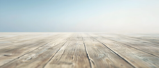 A wooden floor with a blue sky in the background. The floor is empty and has a natural, rustic feel to it - obrazy, fototapety, plakaty