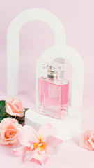 Obraz na płótnie Canvas Transparent bottle of perfume on a pink background. Fragrance presentation with daylight. Trending concept in natural materials with window shadow. Perfume sweet pink roses template for advertising.