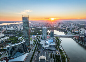 Yekaterinburg city and pond aerial panoramic view at summer sunset.