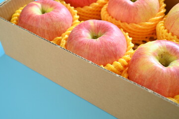 beautiful pink apple in the box on blue background - 781031522