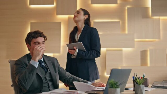 Business losers looking laptop fail at office closeup. Man throwing documents