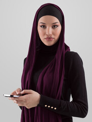 Woman in black stylish fashionable clothes Muslim headscarf. Lady using smart phone, close up portrait of smiling middle eastern girl. - 781033391