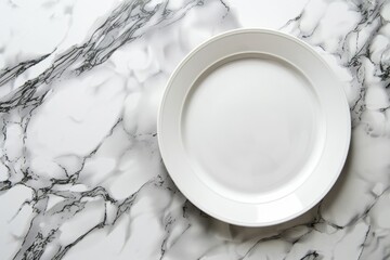 A white plate is placed on top of a marble counter, seen from an overhead side view - obrazy, fototapety, plakaty