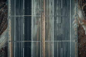 Overhead view of a newly constructed empty highway with multiple lanes winding through picturesque mountains - obrazy, fototapety, plakaty