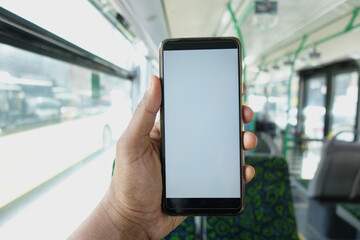passenger sitting in a bus using his phone.