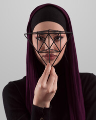 Muslim woman wearing modern stylish wear and hijab isolated on grey background. Diverse people model hijab fashion concept. Face recognition and biometric data identify face science. - 781036593