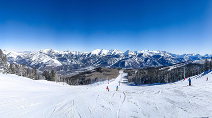 Fototapeta na wymiar A snow covered mountain range with skiers on the slopes