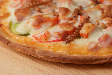 Pizza topped with bamboo worm edible insect crispy mixed with sausage slices, sweet pepper and...