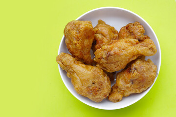 Fried chicken on green background.
